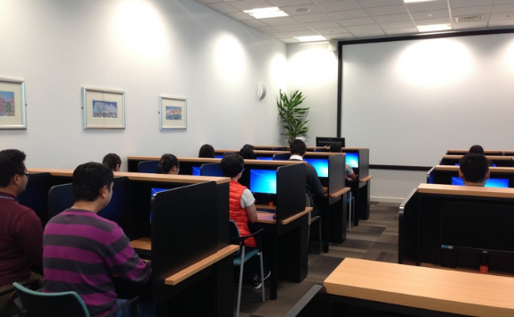Students sit at the workstations in the Economics Lab	